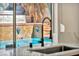 Marble kitchen sink features a view of stunning backyard pool at 3916 Green Leaf Dr, Las Vegas, NV 89120