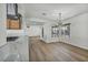 Open floor plan with views from the kitchen into the dining and living spaces with wood-look floors at 3916 Green Leaf Dr, Las Vegas, NV 89120