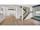 Bright living room featuring a wood staircase, light flooring, and sliding glass doors for seamless indoor/outdoor living at 3916 Green Leaf Dr, Las Vegas, NV 89120