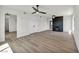 Spacious living room with a modern fireplace, elegant lighting, and wood-style flooring at 3916 Green Leaf Dr, Las Vegas, NV 89120