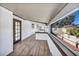 Covered patio with wood-style floors, large windows with neighborhood views, and access door at 3916 Green Leaf Dr, Las Vegas, NV 89120