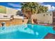 The beautiful pool features a rock waterfall feature and wall fountains for a tranquil outdoor oasis at 3916 Green Leaf Dr, Las Vegas, NV 89120