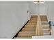 Ascending view of modern staircase with sleek wooden steps and minimalist lighting at 3916 Green Leaf Dr, Las Vegas, NV 89120