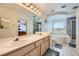 Updated bathroom featuring dual sinks, soaking tub, and separate shower stall at 4 Bishopsgate Ter, Henderson, NV 89074