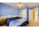 Bright bedroom with blue and yellow walls, a fan, a window, and neutral carpet at 4 Bishopsgate Ter, Henderson, NV 89074