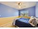 Cheerful bedroom featuring a fan, large window, and neutral carpet at 4 Bishopsgate Ter, Henderson, NV 89074