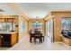 Cozy dining area with a wooden table, window seating, and backyard access at 4 Bishopsgate Ter, Henderson, NV 89074