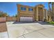 Attractive two-story home showcasing a well-manicured lawn and a wide driveway leading to an attached garage at 4 Bishopsgate Ter, Henderson, NV 89074