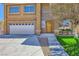 Charming home featuring an attached garage, well-maintained lawn, and inviting front entrance at 4 Bishopsgate Ter, Henderson, NV 89074