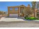 Inviting two-story home showcasing a well-manicured lawn and a spacious driveway leading to an attached garage at 4 Bishopsgate Ter, Henderson, NV 89074