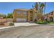 Inviting two-story home featuring a spacious driveway leading to an attached garage and a neatly maintained lawn at 4 Bishopsgate Ter, Henderson, NV 89074