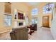 Bright living room featuring high ceilings, large windows, a fireplace, and comfortable seating at 4 Bishopsgate Ter, Henderson, NV 89074