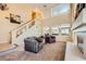 Spacious living room with a fireplace, high ceilings, large windows, and cozy seating area at 4 Bishopsgate Ter, Henderson, NV 89074