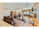 Open-concept living room featuring a brick fireplace, large sofa, and lots of natural light at 4 Bishopsgate Ter, Henderson, NV 89074
