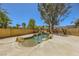Backyard pool featuring a rock waterfall and mature trees for a serene and inviting oasis at 4 Bishopsgate Ter, Henderson, NV 89074