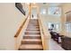 Carpeted staircase with white banister and a wooden handrail leading to the second floor at 4 Bishopsgate Ter, Henderson, NV 89074
