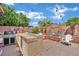 Relaxing backyard with an outdoor kitchen, a firepit, and mature landscaping at 4330 Oasis Hill Ave, North Las Vegas, NV 89085