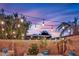 Backyard showcasing string lights, lush trees, and comfortable seating, perfect for outdoor entertaining at 4330 Oasis Hill Ave, North Las Vegas, NV 89085