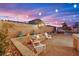 Picturesque backyard featuring a stone fire pit, seating, and string lights for relaxed outdoor evenings at 4330 Oasis Hill Ave, North Las Vegas, NV 89085