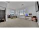 Large bedroom with an ensuite bathroom, work space, large windows and carpet flooring at 4330 Oasis Hill Ave, North Las Vegas, NV 89085
