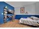 Stylish bedroom featuring a sleek workstation, floating shelves, and a comfortable bed at 4330 Oasis Hill Ave, North Las Vegas, NV 89085