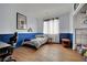 Bedroom with light and dark blue walls, wood floors, window, and built in closet at 4330 Oasis Hill Ave, North Las Vegas, NV 89085