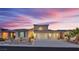 Beautiful two-story home with a three car garage and desert landscaping against a colorful sunset at 4330 Oasis Hill Ave, North Las Vegas, NV 89085