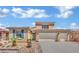 Charming two-story home with a three-car garage, desert landscaping and blue sky backdrop at 4330 Oasis Hill Ave, North Las Vegas, NV 89085