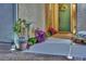Charming front entrance with a welcoming green door, decorative plants, and warm exterior lighting at 4330 Oasis Hill Ave, North Las Vegas, NV 89085
