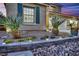 Well-maintained front yard features desert landscaping, decorative rocks, and charming exterior lighting at 4330 Oasis Hill Ave, North Las Vegas, NV 89085