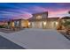 Stunning three-car garage home exterior with beautiful desert landscaping and ample driveway space at 4330 Oasis Hill Ave, North Las Vegas, NV 89085