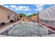 Backyard with a hot tub, a patio, a grill, and outdoor furniture under blue sky at 4330 Oasis Hill Ave, North Las Vegas, NV 89085