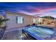 Relaxing backyard featuring a hot tub and built in outdoor kitchen area at 4330 Oasis Hill Ave, North Las Vegas, NV 89085