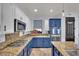 Bright kitchen with blue and white cabinets, granite counters, and stainless steel appliances at 4330 Oasis Hill Ave, North Las Vegas, NV 89085