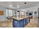 Spacious kitchen with granite counters, stainless appliances, island with seating, and open view to the living room at 4330 Oasis Hill Ave, North Las Vegas, NV 89085