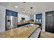 Modern kitchen features granite counters, stainless steel appliances, and beautiful blue and white cabinetry at 4330 Oasis Hill Ave, North Las Vegas, NV 89085