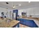 Updated kitchen featuring stainless appliances, white and blue cabinets, and granite countertops at 4330 Oasis Hill Ave, North Las Vegas, NV 89085