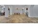 Open-concept living room with tile flooring, white walls, and archways at 4330 Oasis Hill Ave, North Las Vegas, NV 89085