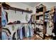 Spacious walk-in closet features wood shelves, hanging rods, and ample storage for organized wardrobe solutions at 4330 Oasis Hill Ave, North Las Vegas, NV 89085