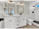 Elegant bathroom featuring a dual sink vanity, framed mirrors, and walk-in shower at 4375 Pittsfield St, Las Vegas, NV 89115