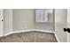 Neutral bedroom featuring carpeted floor, a window providing natural light, and painted in a light shade at 4375 Pittsfield St, Las Vegas, NV 89115