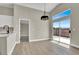 Dining area illuminated with natural light, wood flooring, and sliding glass door to the outdoors at 4375 Pittsfield St, Las Vegas, NV 89115