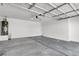 Spacious garage with concrete floor, insulated door, and utility connections at 4375 Pittsfield St, Las Vegas, NV 89115