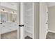 White linen closet with 5 shelves inside of primary bathroom with dual sinks at 4375 Pittsfield St, Las Vegas, NV 89115