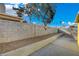 Spacious backyard with a concrete block wall and a gravel-filled landscape at 4419 Fairmont Cir, Las Vegas, NV 89147