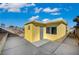 Bright yellow exterior with a concrete patio in the backyard of this charming home at 4419 Fairmont Cir, Las Vegas, NV 89147