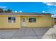 The backyard is simple and clean, featuring yellow walls and concrete flooring at 4419 Fairmont Cir, Las Vegas, NV 89147