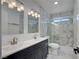 Bathroom featuring double sinks, marble backsplash and shower with glass door at 4419 Fairmont Cir, Las Vegas, NV 89147