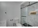 Contemporary bathroom with tiled shower, glass door, and modern fixtures at 4419 Fairmont Cir, Las Vegas, NV 89147