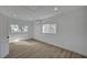 Bright bedroom with modern wood-look flooring, recessed lights, and windows providing natural light at 4419 Fairmont Cir, Las Vegas, NV 89147